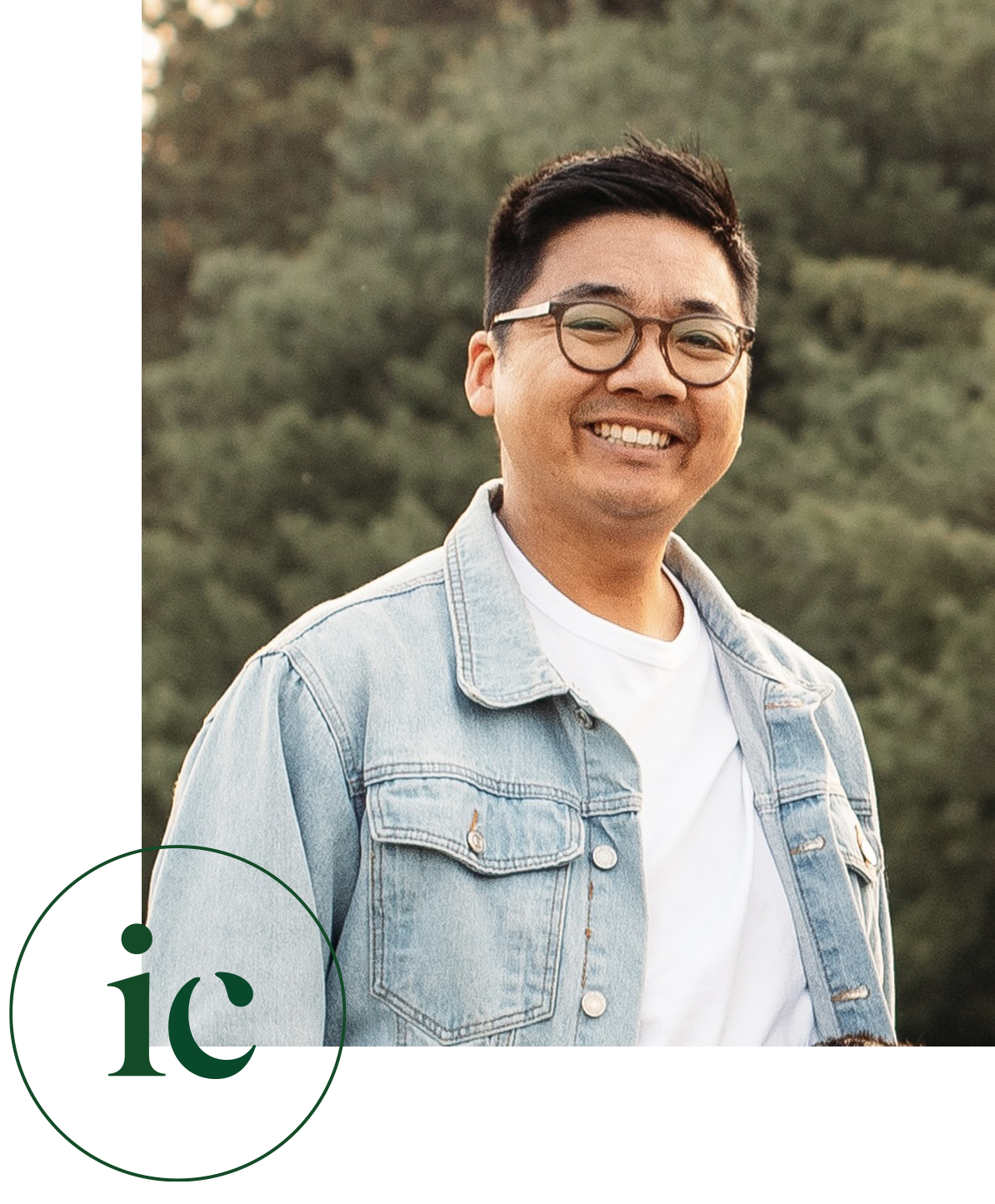 Iven Chung, registered psychotherapist in Kitchener-Waterloo, smiling outdoors in a denim jacket, conveying a warm and approachable demeanour.